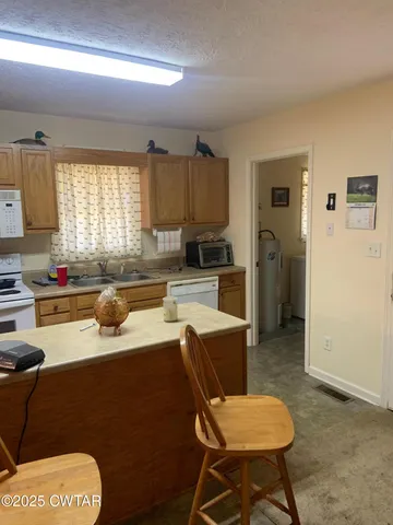 a kitchen with a sink a stove and a refrigerator