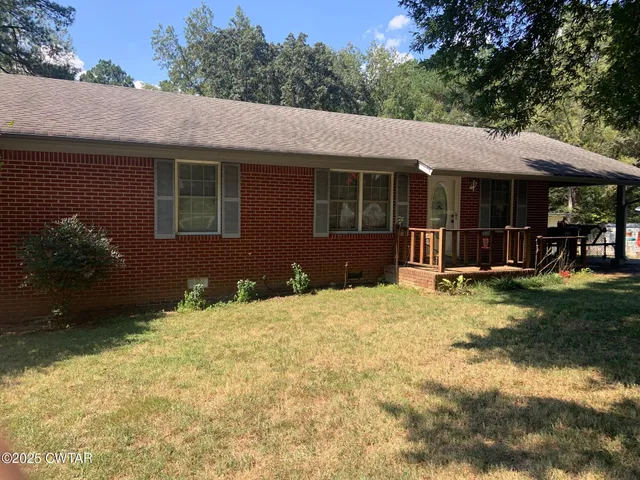a backyard of a house with yard barbeque oven and outdoor seating