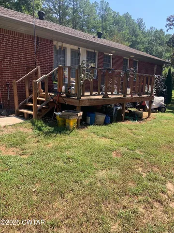 a view of a house with swimming pool and sitting area