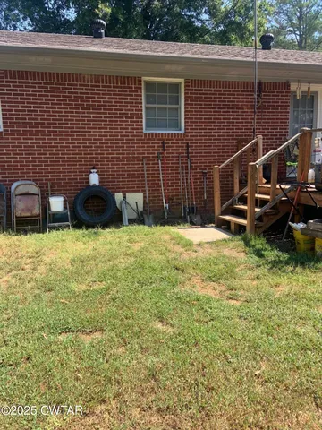 a backyard of a house with table and chairs