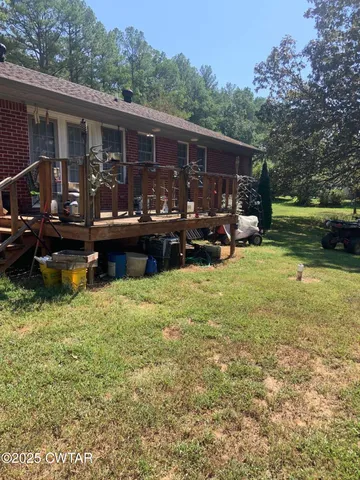 a view of house with backyard space and balcony