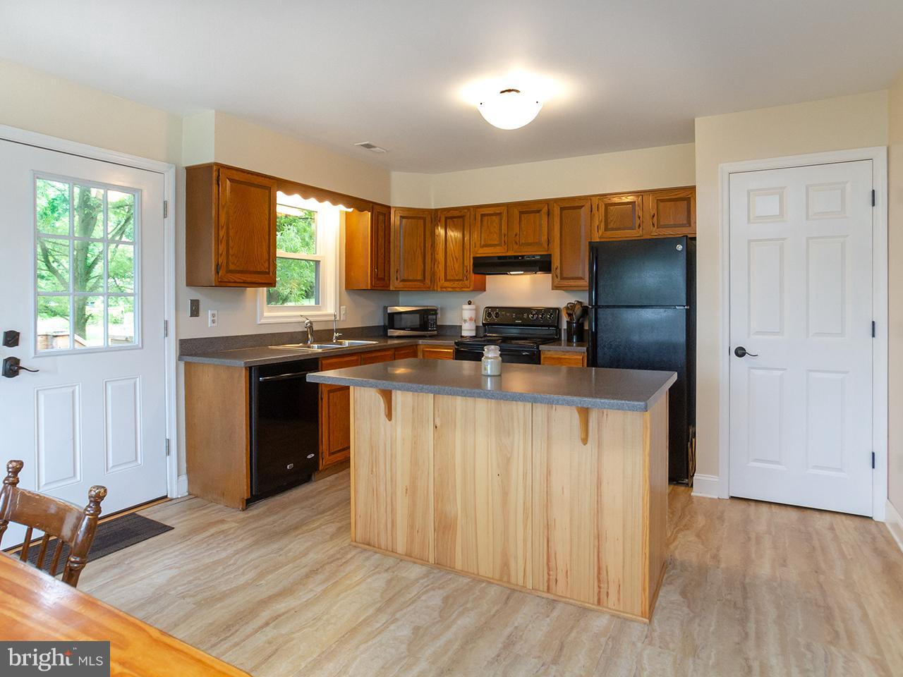 17521 Troyer Road Monkton, MD 21111 - Photo 2 of 29 a kitchen with stainless steel appliances a stove top oven a sink and a refrigerator