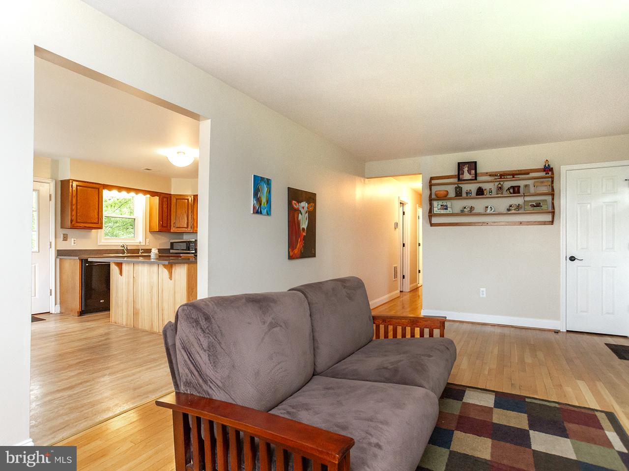 17521 Troyer Road Monkton, MD 21111 - Photo 7 of 29 a living room with furniture and a dining table with wooden floor
