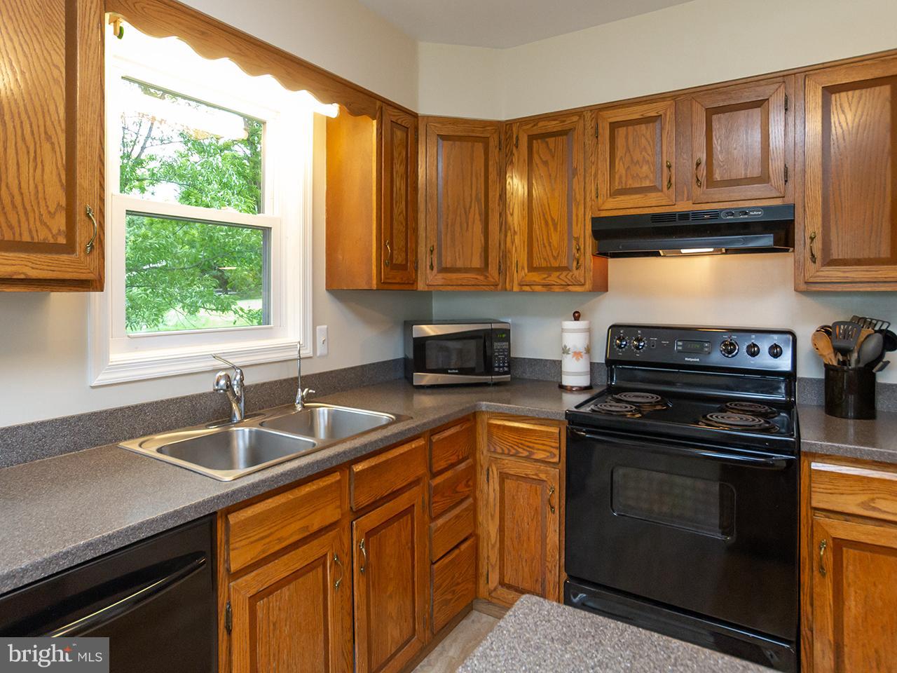 17521 Troyer Road Monkton, MD 21111 - Photo 9 of 29 a kitchen with granite countertop a sink stainless steel appliances and cabinets