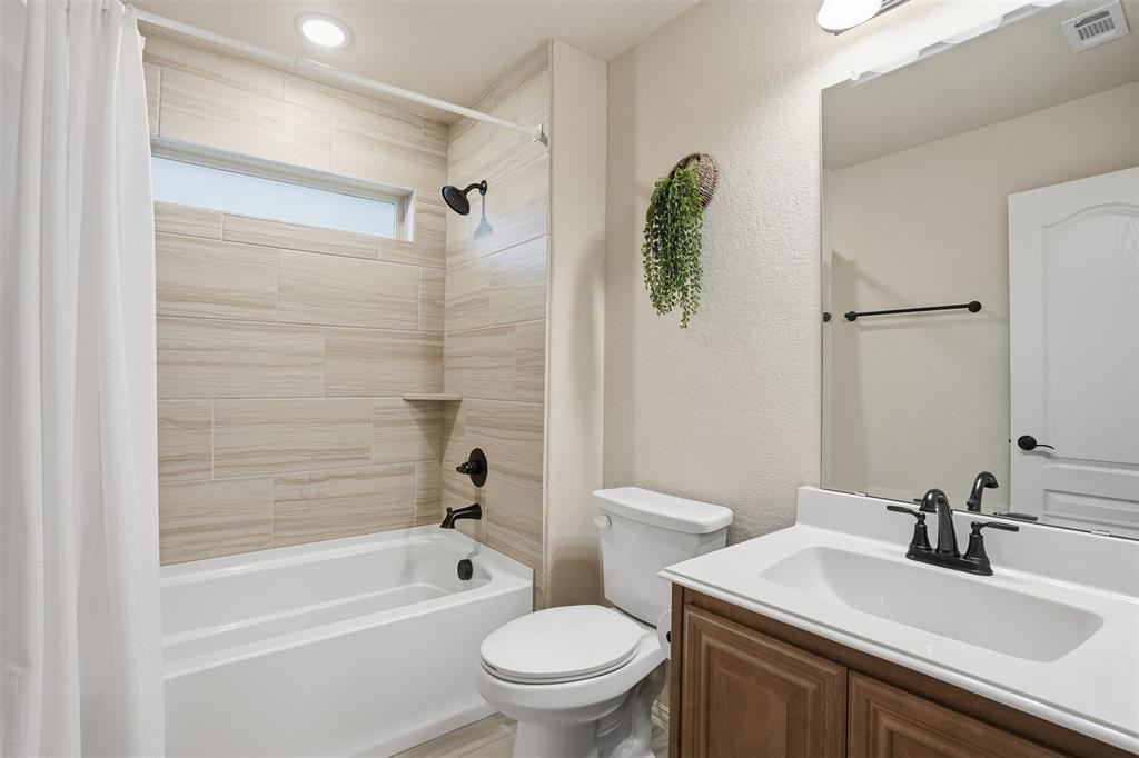 4002 Grove Valley Road Midlothian, TX 76065 - Photo 33 of 40 a bathroom with a sink toilet and shower
