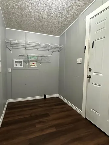 a view of a room with wooden floor