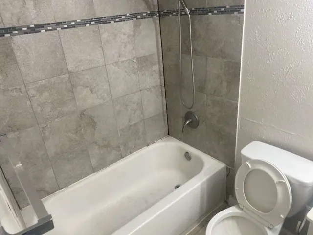 a bathroom with a sink a toilet and bathtub