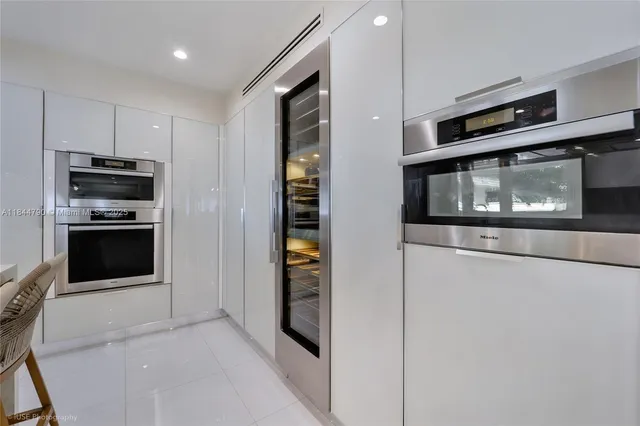 a kitchen with stainless steel appliances a stove microwave and refrigerator