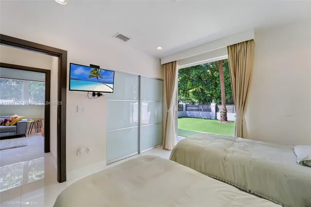 a bedroom with a bed and a painting on the wall