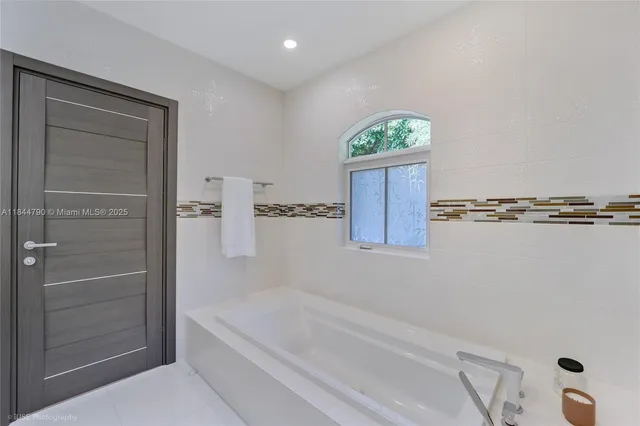 a bathroom with a bathtub and shower