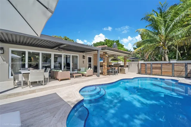 a view of a house with swimming pool and sitting area