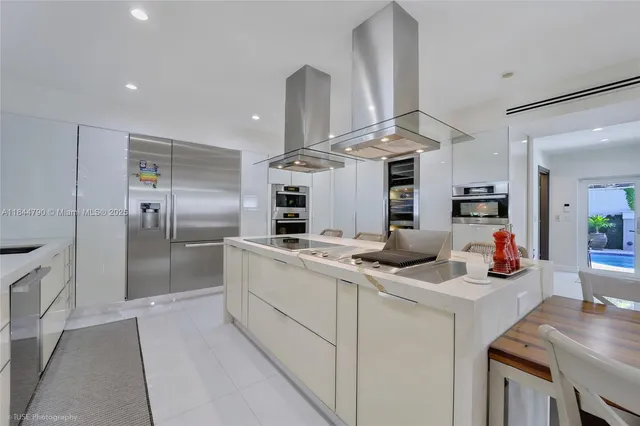 a kitchen with stainless steel appliances a sink stove and refrigerator