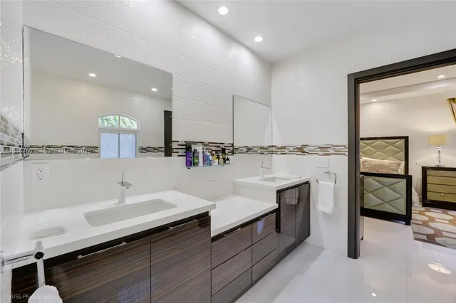 a bathroom with a sink double vanity and a mirror