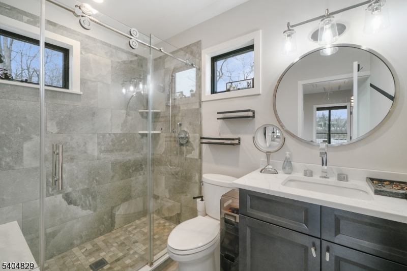 71 Witte Road West Milford, NJ 07421 - Photo 13 of 42 a bathroom with a sink toilet a mirror and shower