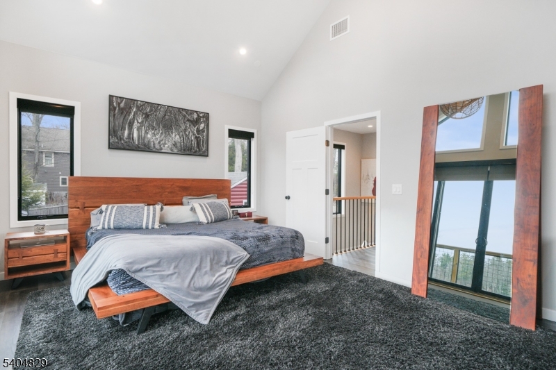 71 Witte Road West Milford, NJ 07421 - Photo 19 of 42 a bedroom with a bed and a view of en suite bathroom