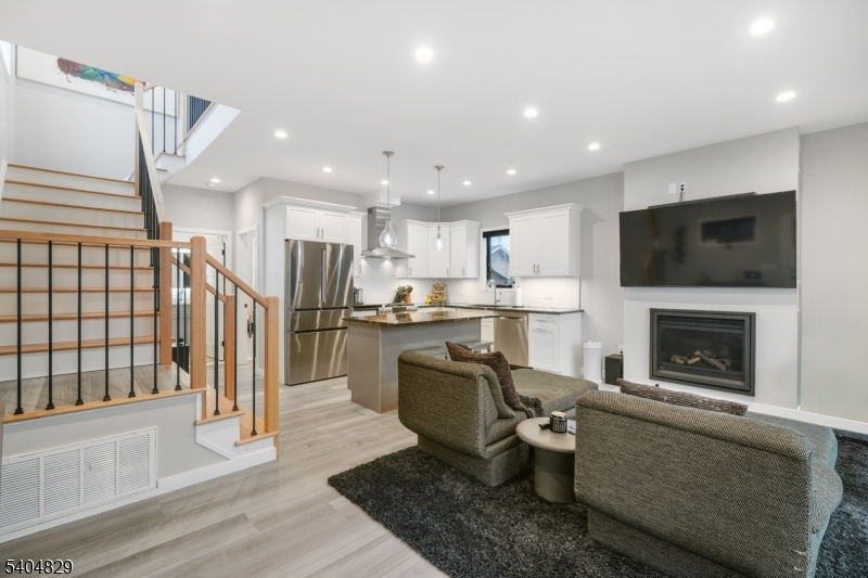 71 Witte Road West Milford, NJ 07421 - Photo 2 of 42 a living room with wooden floor and a fireplace