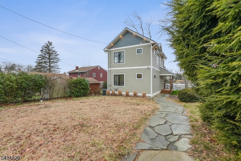 71 Witte Road West Milford, NJ 07421 - Photo 40 of 42 a front view of a house with a yard and garage