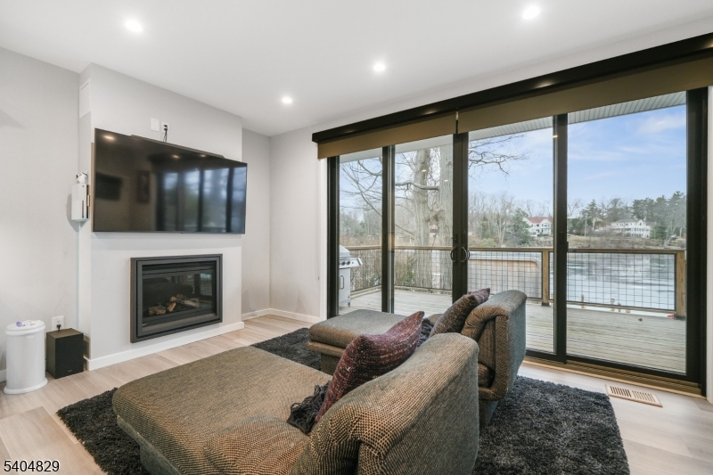71 Witte Road West Milford, NJ 07421 - Photo 9 of 42 a living room with furniture tv and a fireplace