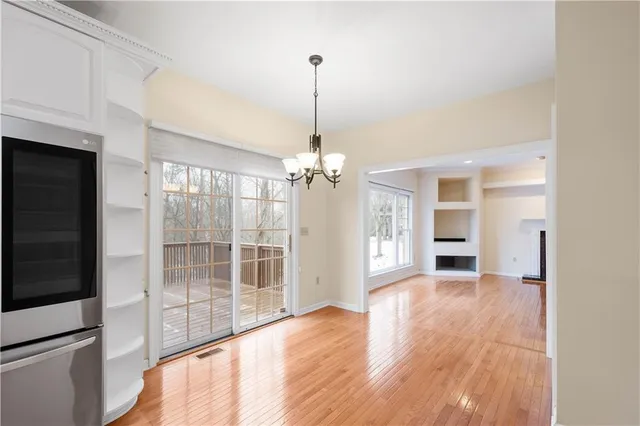 a view of a room with wooden floor and windows