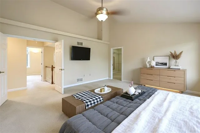 a bedroom with a bed and a television