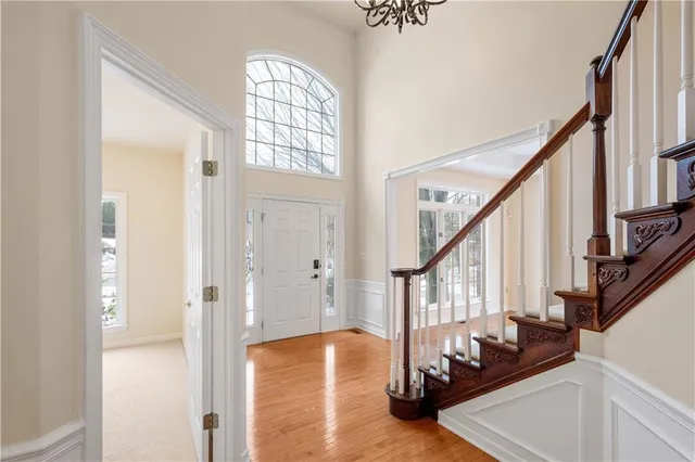 a view of an entryway with wooden floor and door