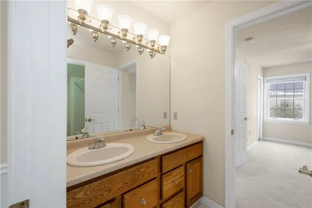 a bathroom with a sink double vanity and a mirror