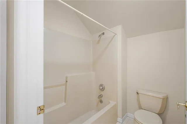 a bathroom with a toilet and a bathtub