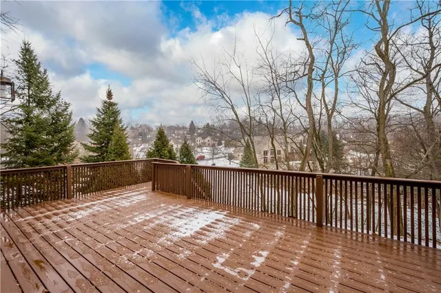 a view of balcony with wooden floor and fence