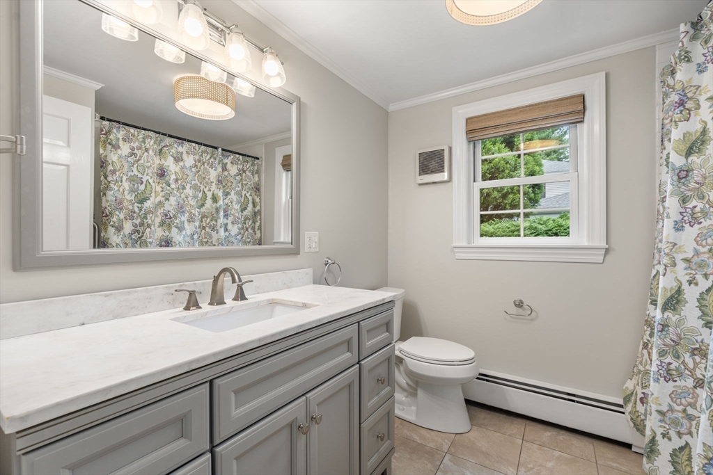 92 Abbot Street Andover, MA 01810 - Photo 21 of 35 a bathroom with a sink a toilet a mirror and a window