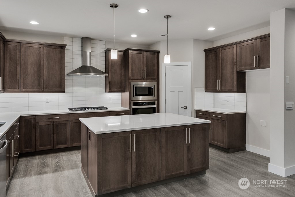 4012 171st Place Southeast Bothell, WA 98012 - Photo 14 of 28 a kitchen with stainless steel appliances granite countertop wooden cabinets a refrigerator and a stove