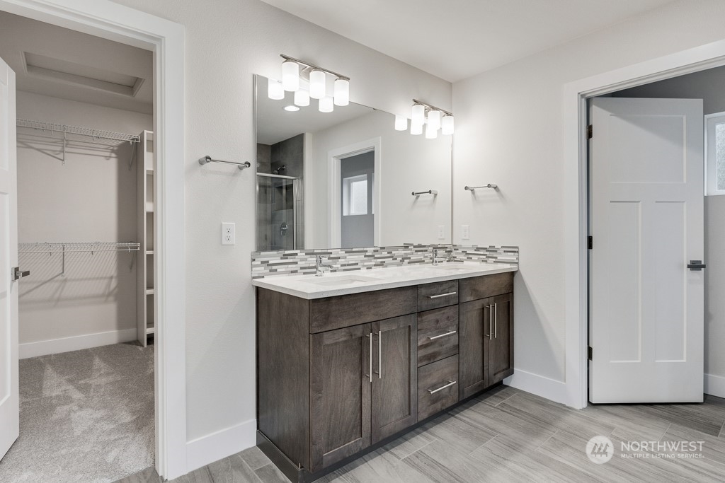 4012 171st Place Southeast Bothell, WA 98012 - Photo 19 of 28 a bathroom with a granite countertop sink a large mirror and a shower