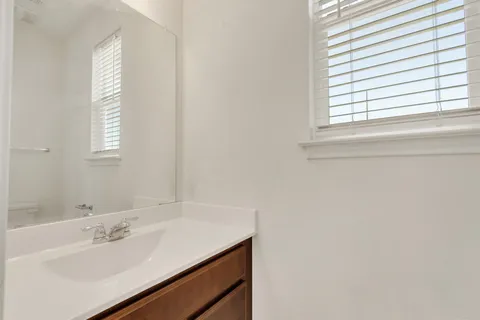 a bathroom with a sink and a window