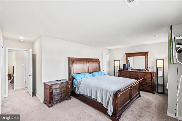 a bedroom with a bed and dresser