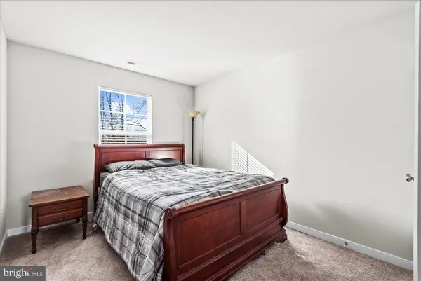 a bedroom with a bed and dresser