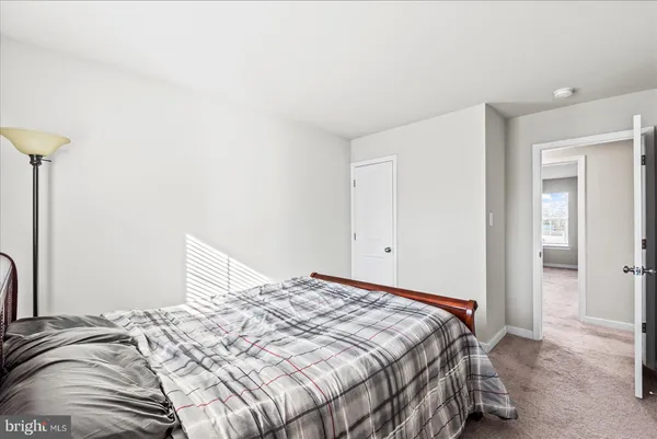 a bedroom with a bed and a mirror