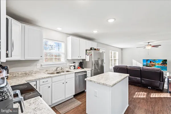 a kitchen that has a sink and a stove top oven