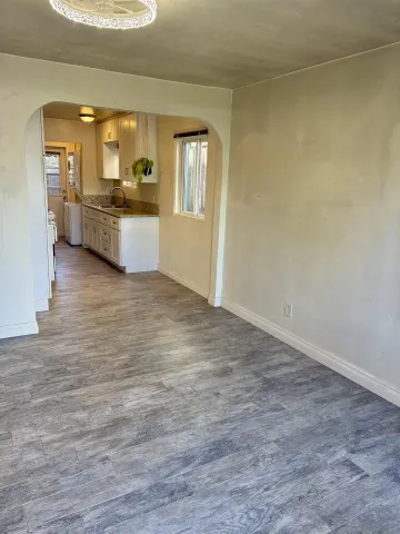 an empty room with a kitchen and a sink