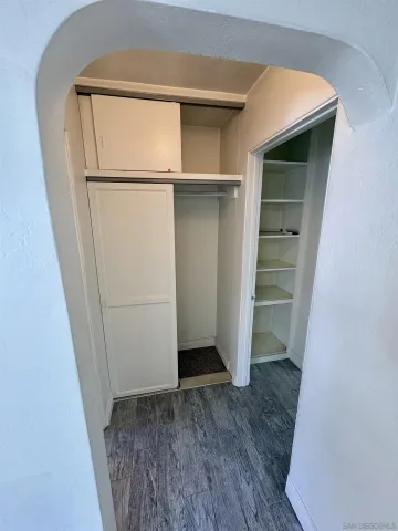 a view of walk in closet with empty racks