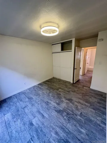 an empty room with wooden floor