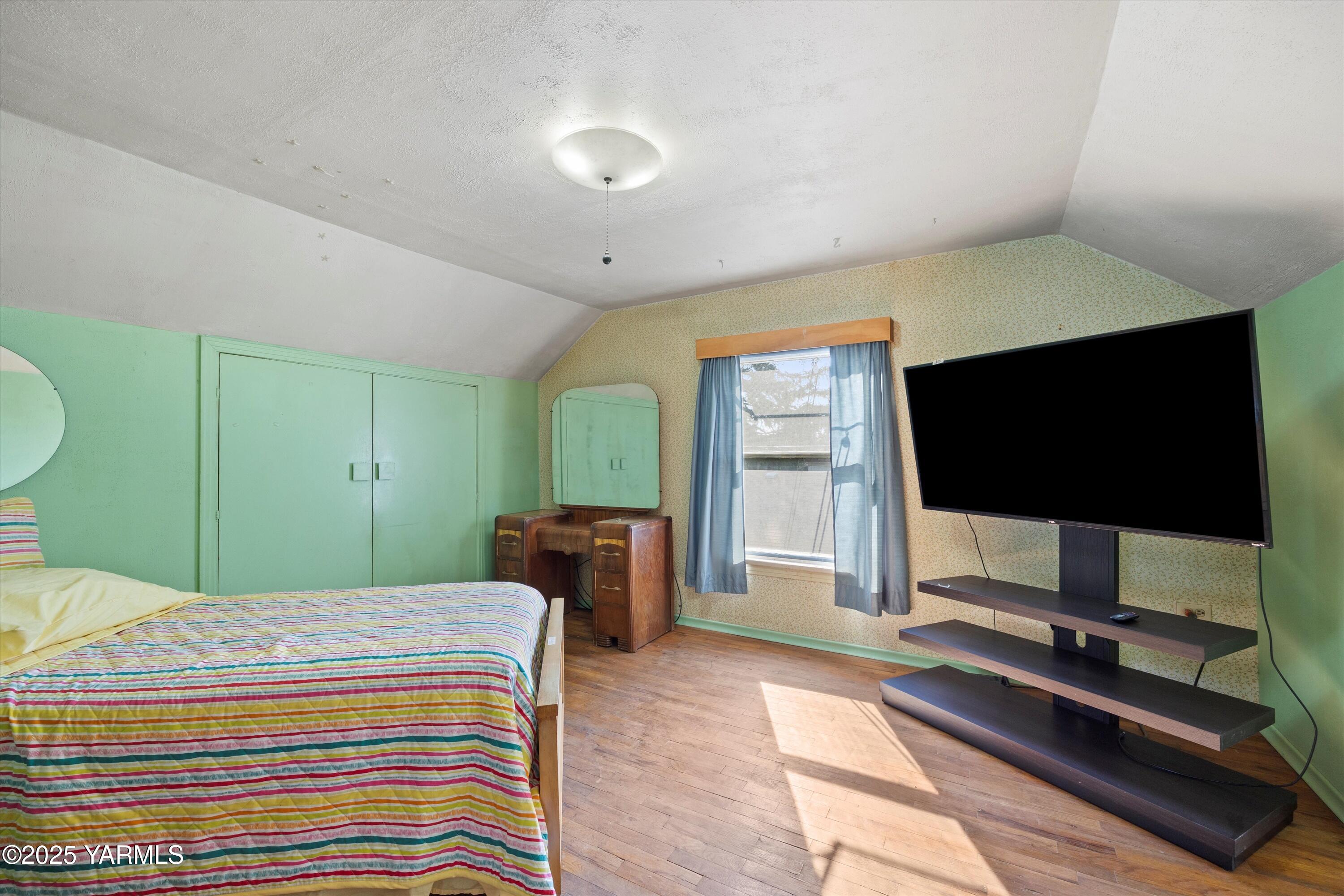 305 South 9th Street Yakima, WA 98901 - Photo 11 of 43 a bedroom with a bed and a flat screen tv