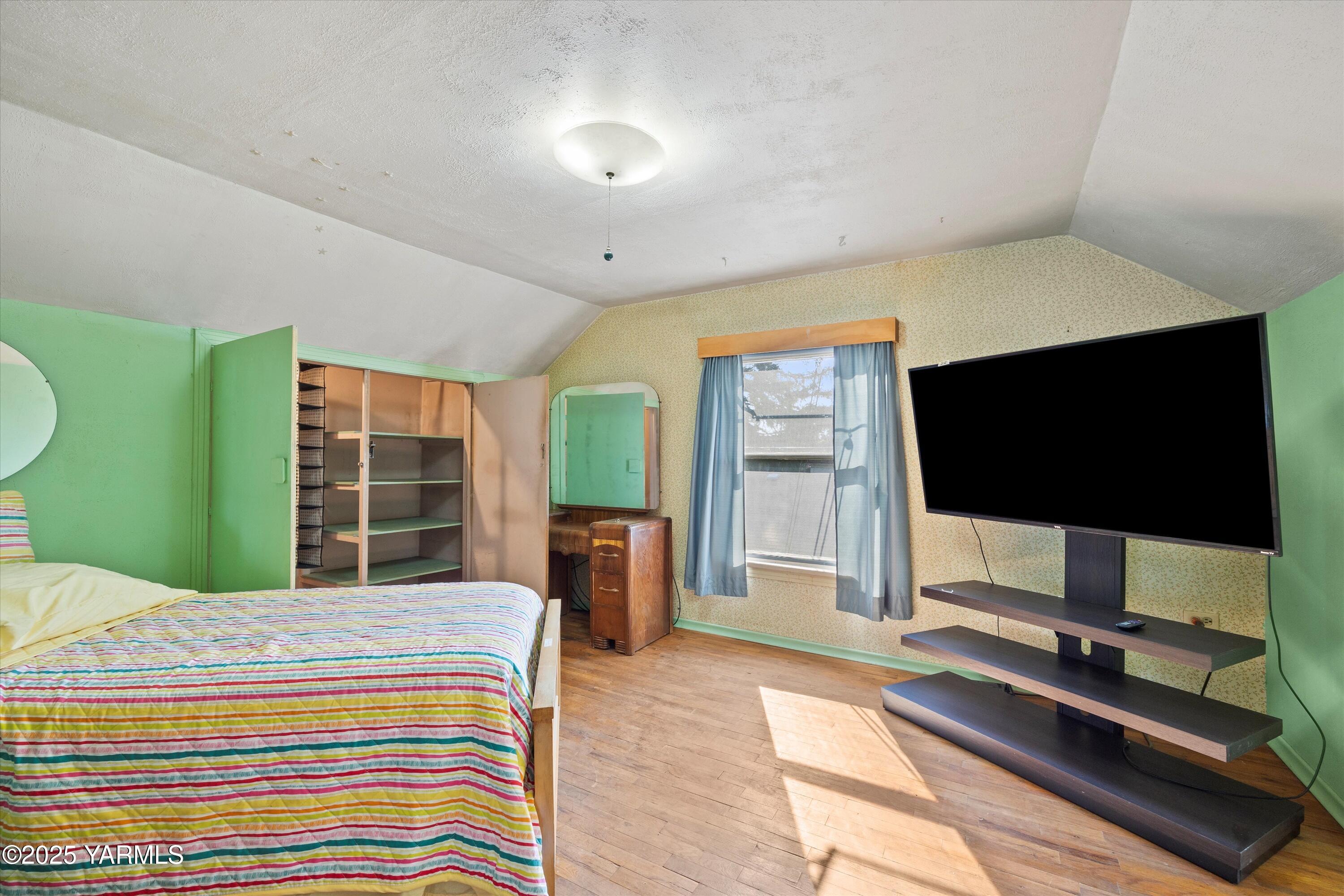 305 South 9th Street Yakima, WA 98901 - Photo 12 of 43 a bedroom with a bed and a flat screen tv