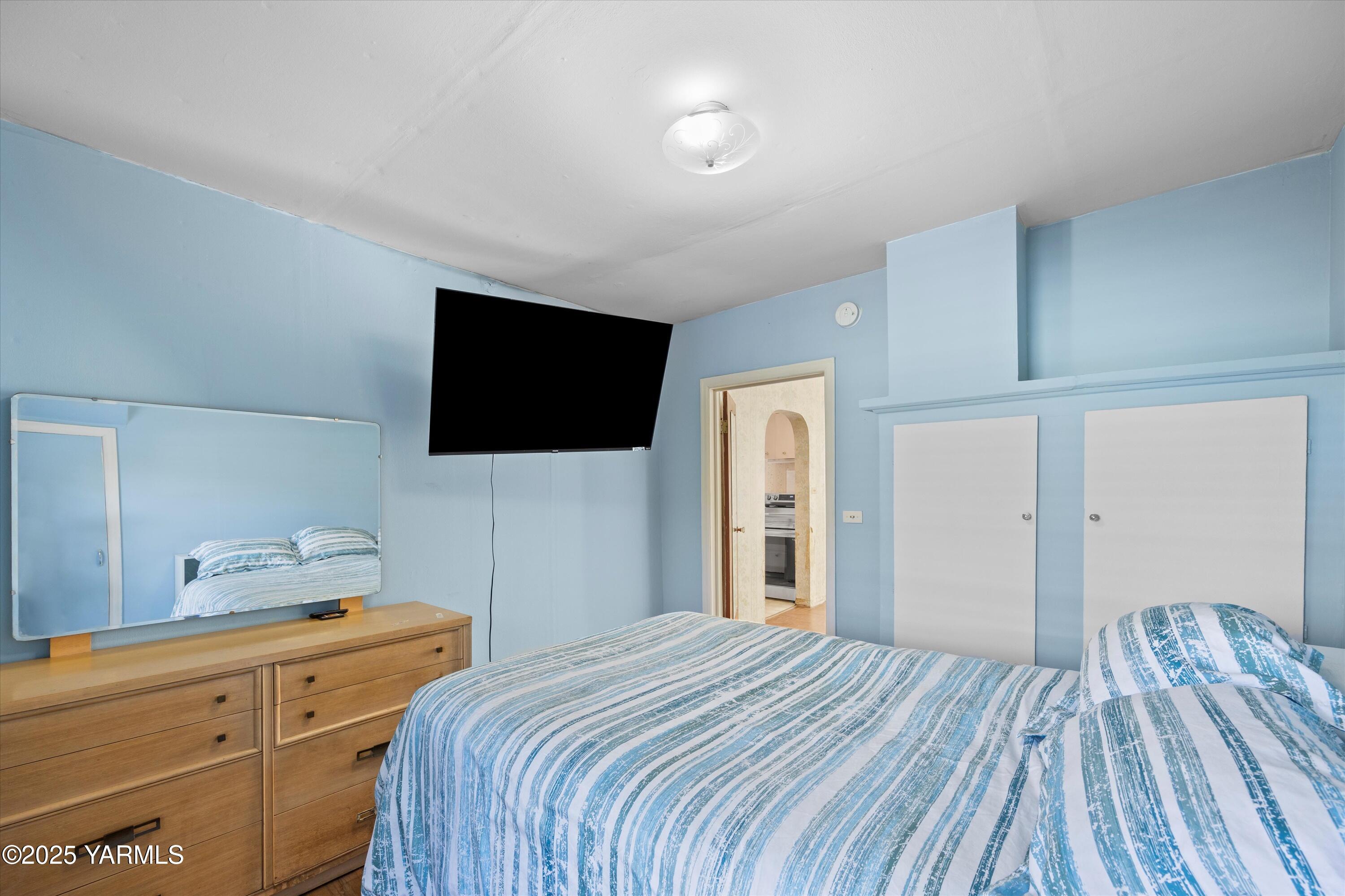 305 South 9th Street Yakima, WA 98901 - Photo 24 of 43 a bedroom with a bed and a flat screen tv