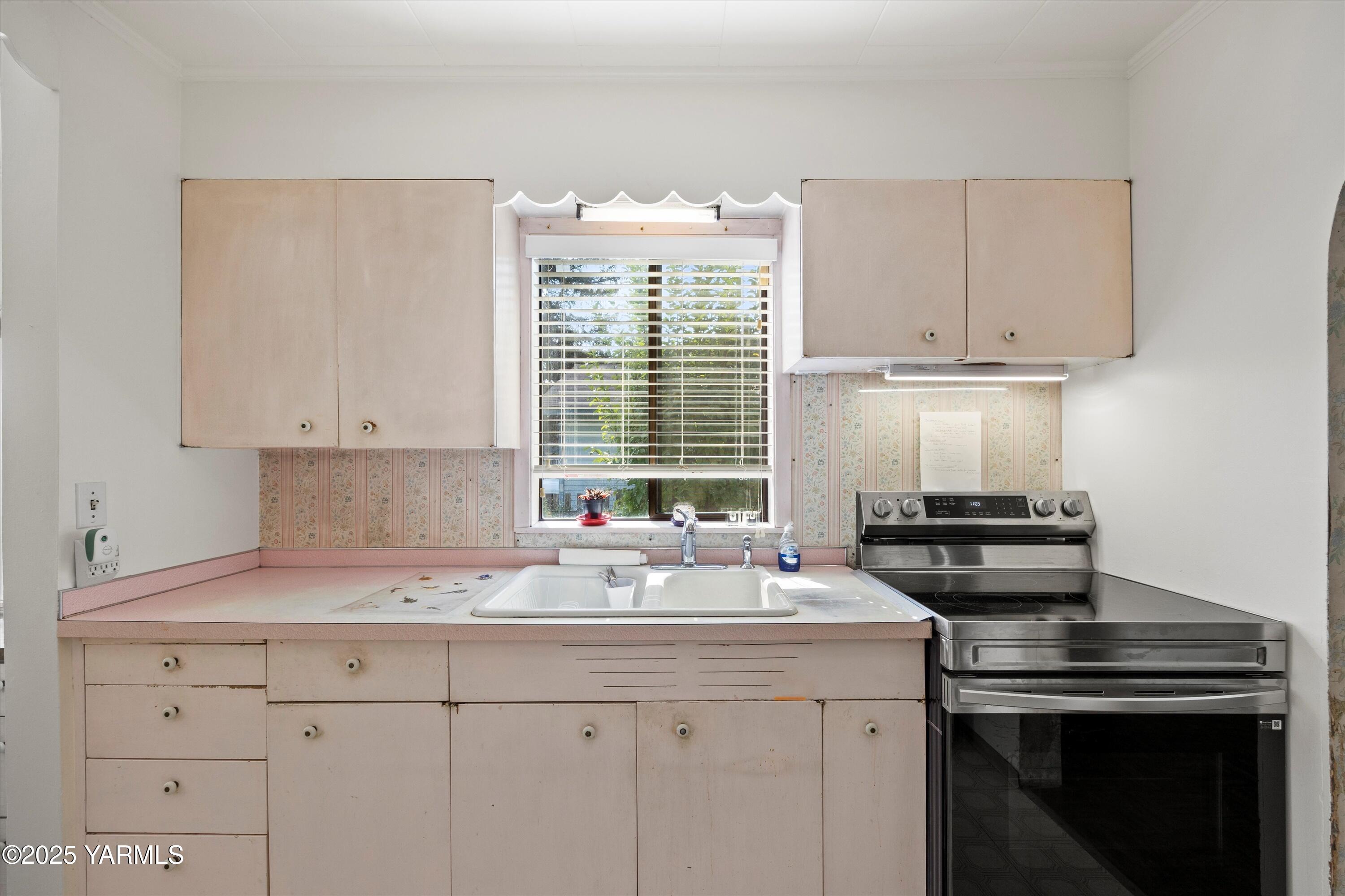 305 South 9th Street Yakima, WA 98901 - Photo 30 of 43 a kitchen with granite countertop a sink cabinets stainless steel appliances and a window