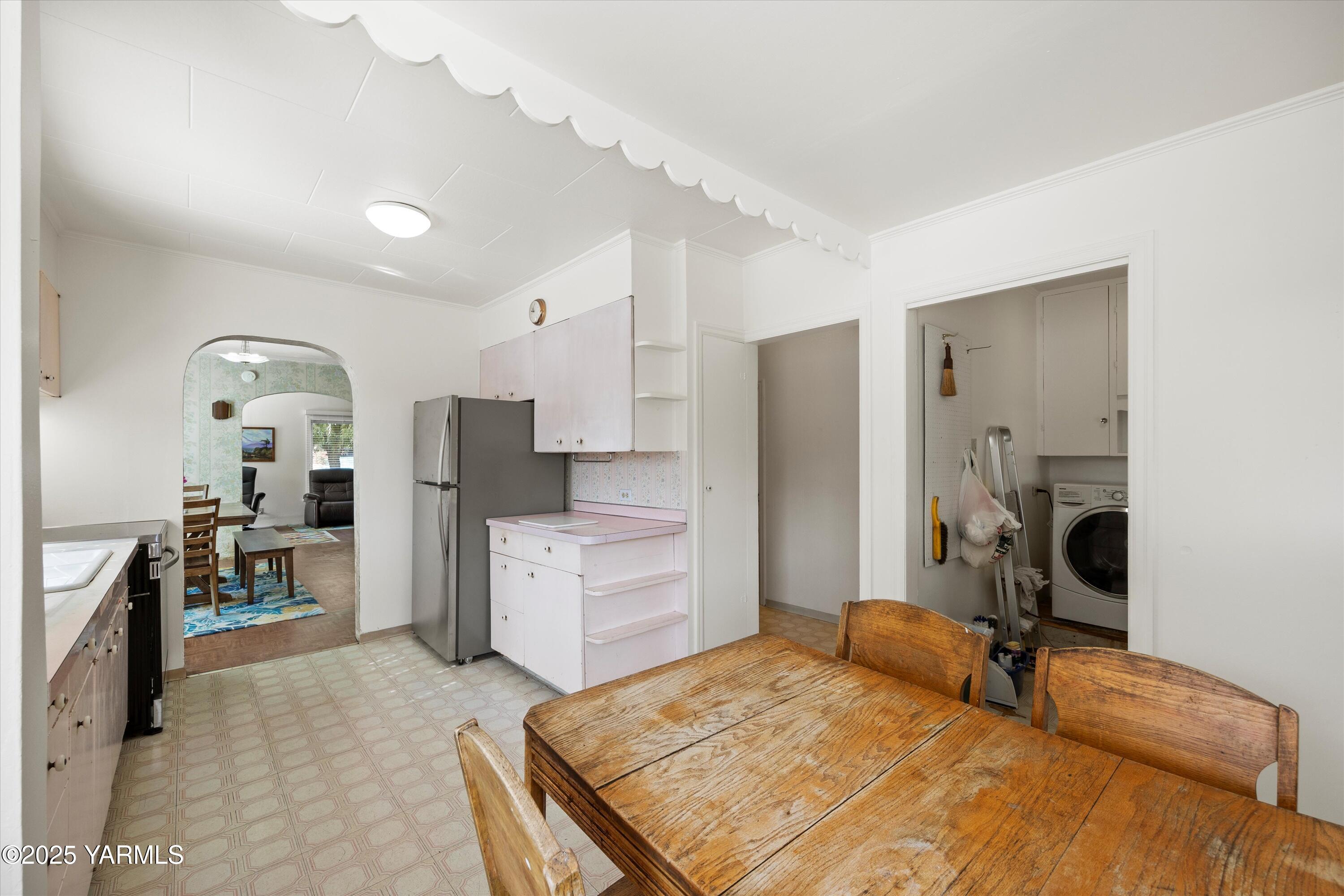 305 South 9th Street Yakima, WA 98901 - Photo 34 of 43 a bedroom with a bed and a chandelier