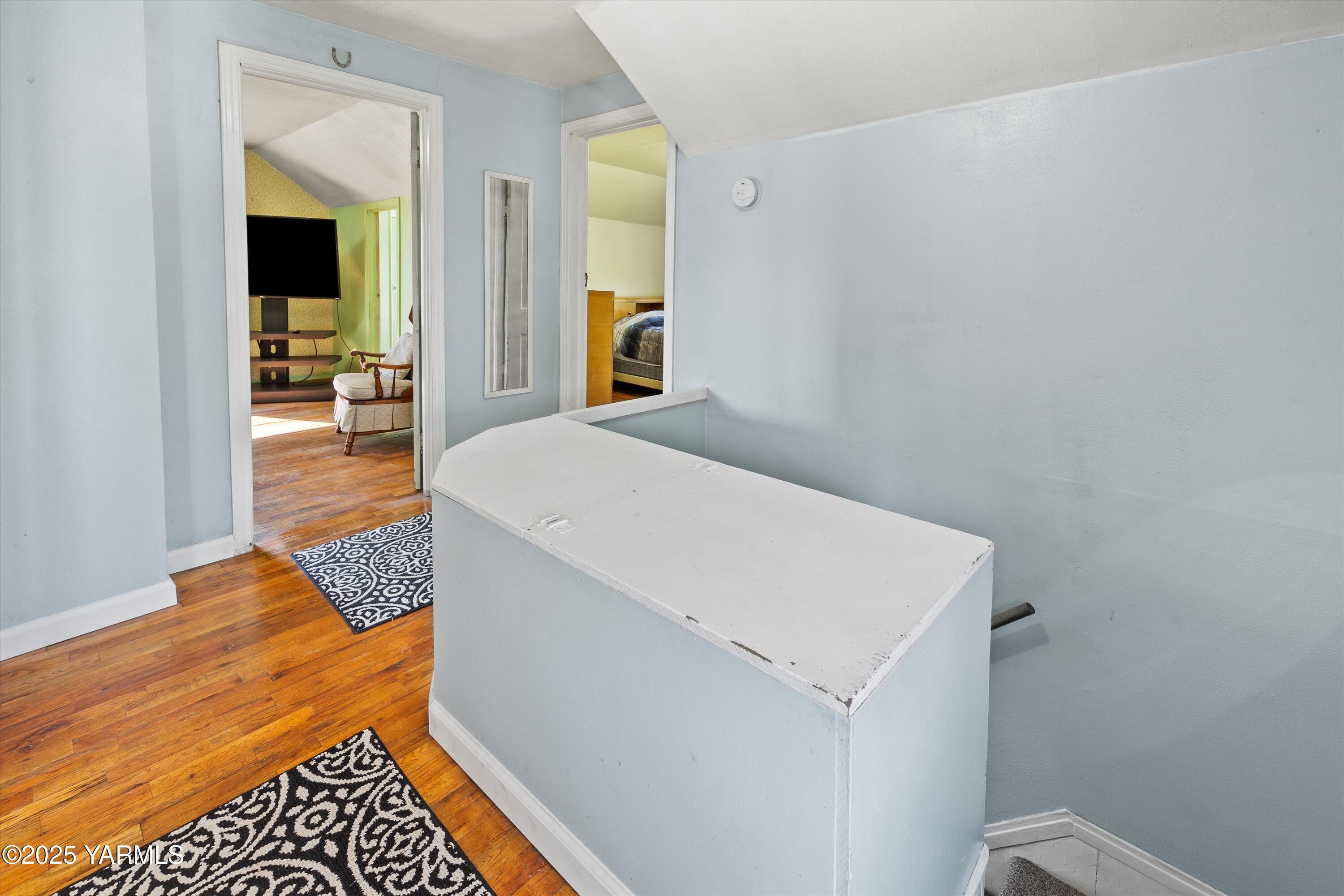 305 South 9th Street Yakima, WA 98901 - Photo 5 of 43 a bedroom with a bed and wooden floor