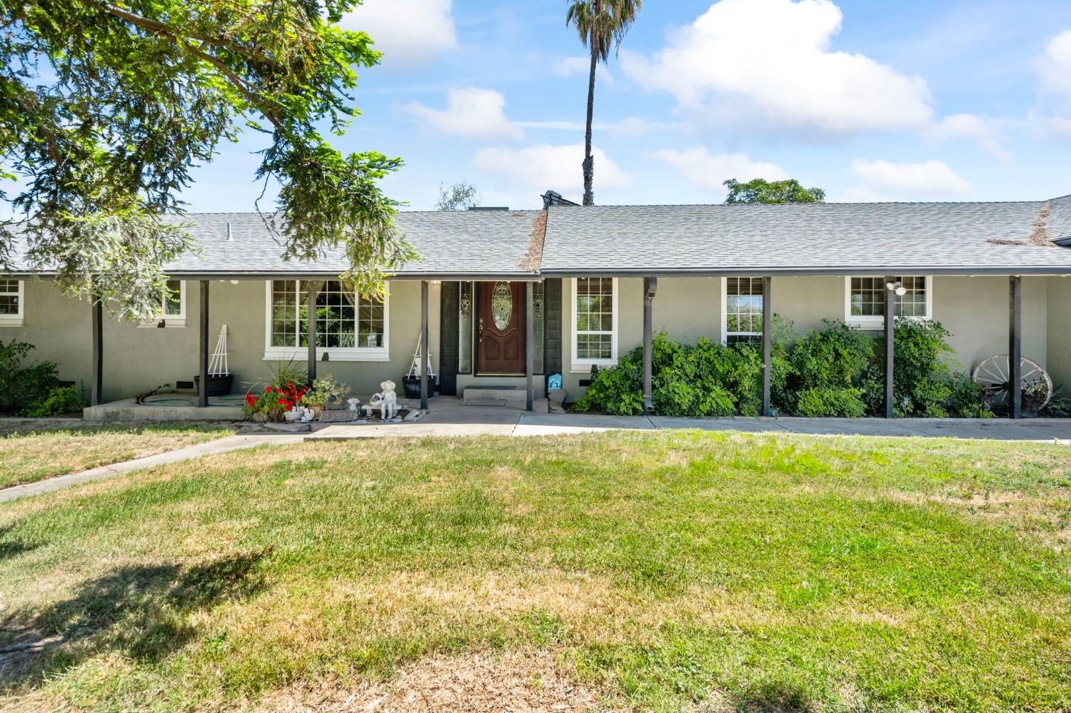 266 South Hewitt Road Linden, CA 95236 - Photo 1 of 1 a front view of house with yard and outdoor seating