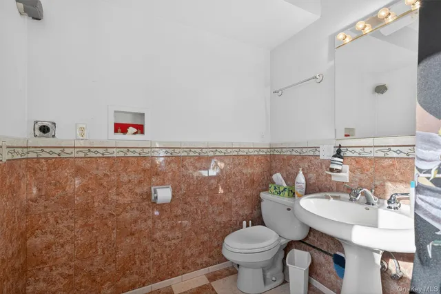a bathroom with a sink mirror vanity and toilet