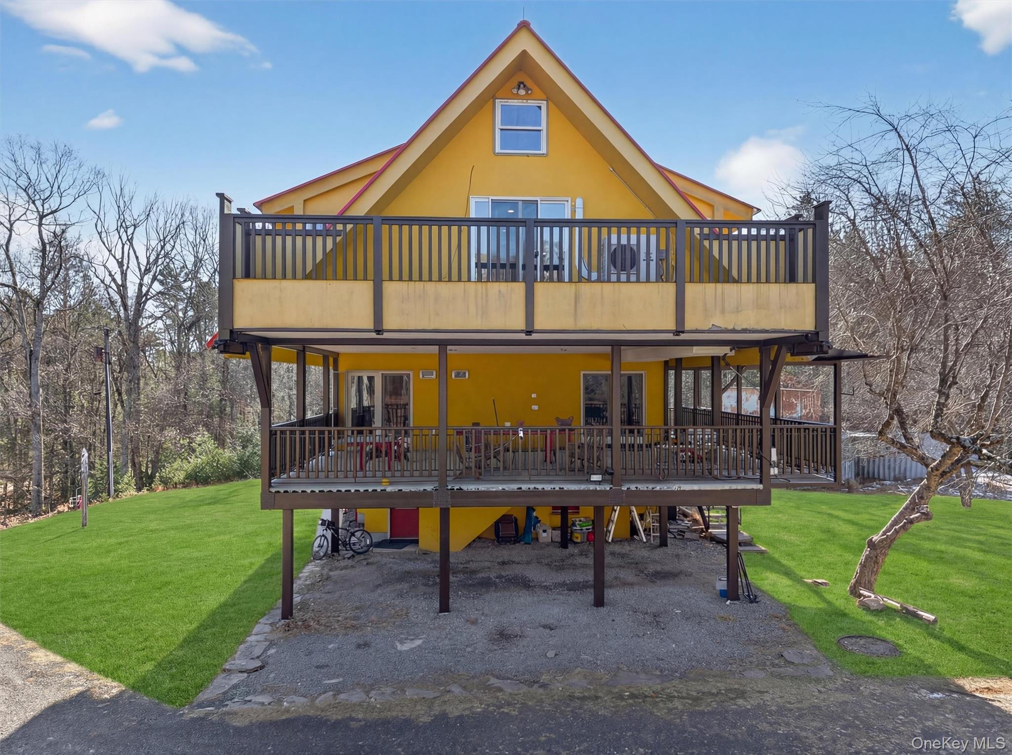 125 Dexheimer Road Narrowsburg, NY 12764 - Photo 2 of 50 Rustic home with a front lawn, a carport, stucco siding, and a wooden deck