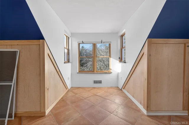 a view of room with window and refrigerator