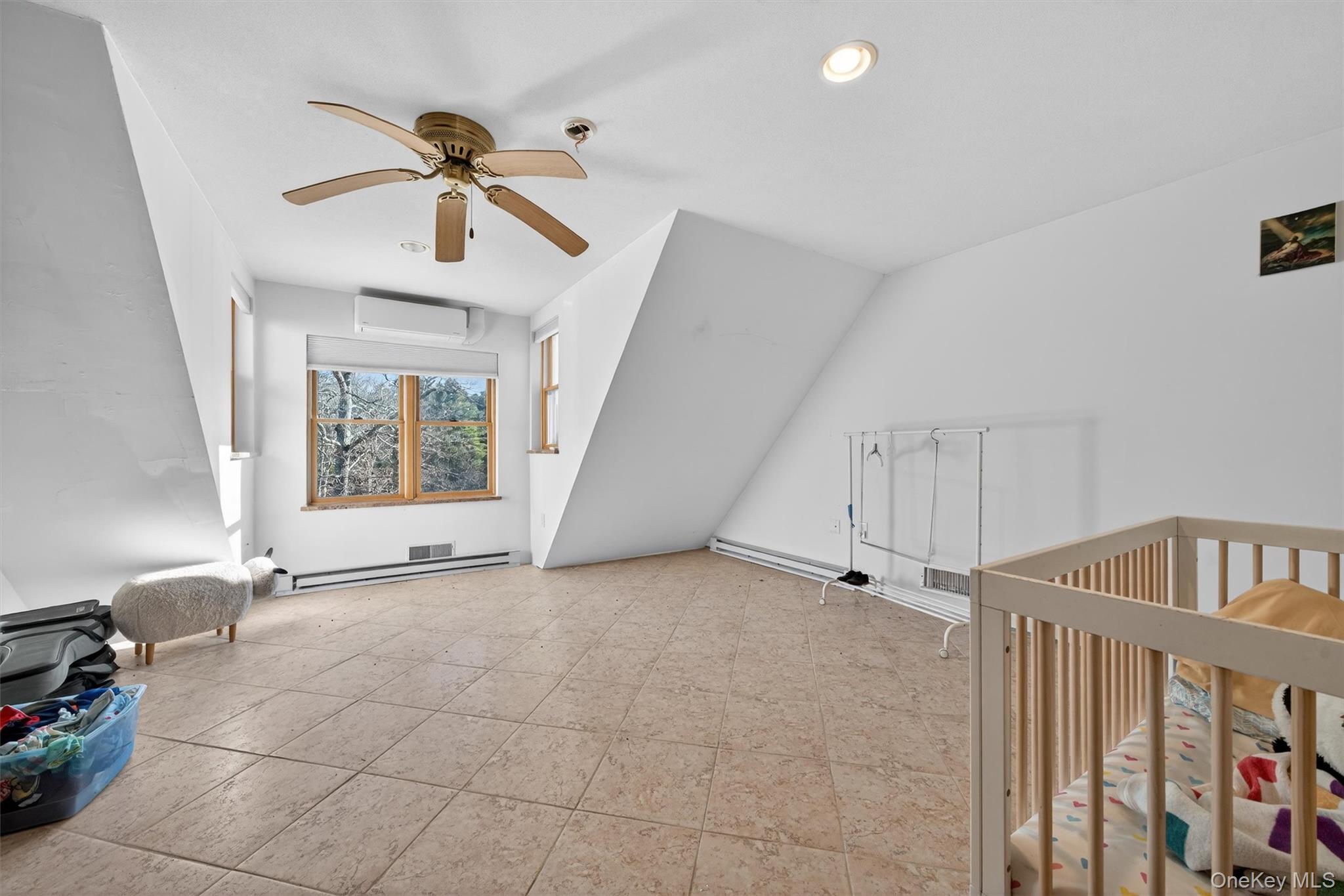 125 Dexheimer Road Narrowsburg, NY 12764 - Photo 22 of 50 Additional living space featuring ceiling fan, a baseboard heating unit, and a wall mounted air conditioner